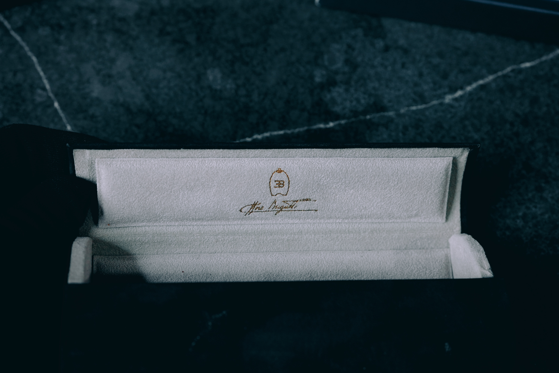 Open suede case with gold Ettore Bugatti signature